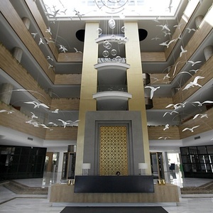 a hotel lobby with birds hanging from the ceiling