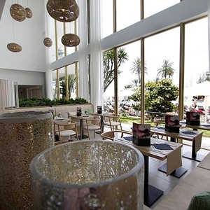 a restaurant with tables and chairs and a large window