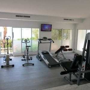 un gimnasio con una cinta de correr y una bicicleta de ejercicio