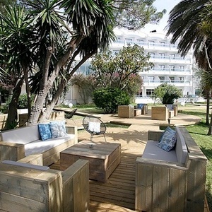 a wooden deck with a couch and chairs on it