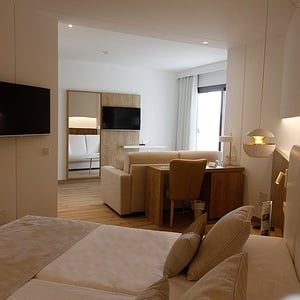 a hotel room with a flat screen tv on the wall