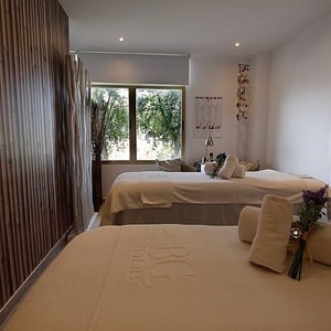 two beds in a room that says j & g beauty