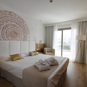 a hotel room with a bed and a chair