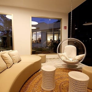 a living room with a couch and a bubble chair