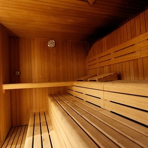 a wooden sauna with a clock on the wall