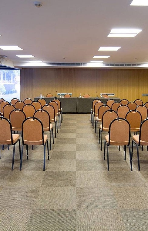 rows of chairs and tables in a conference room