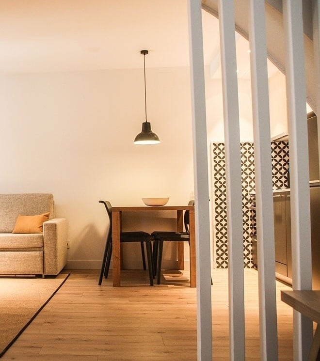 a living room with a couch and a table and chairs