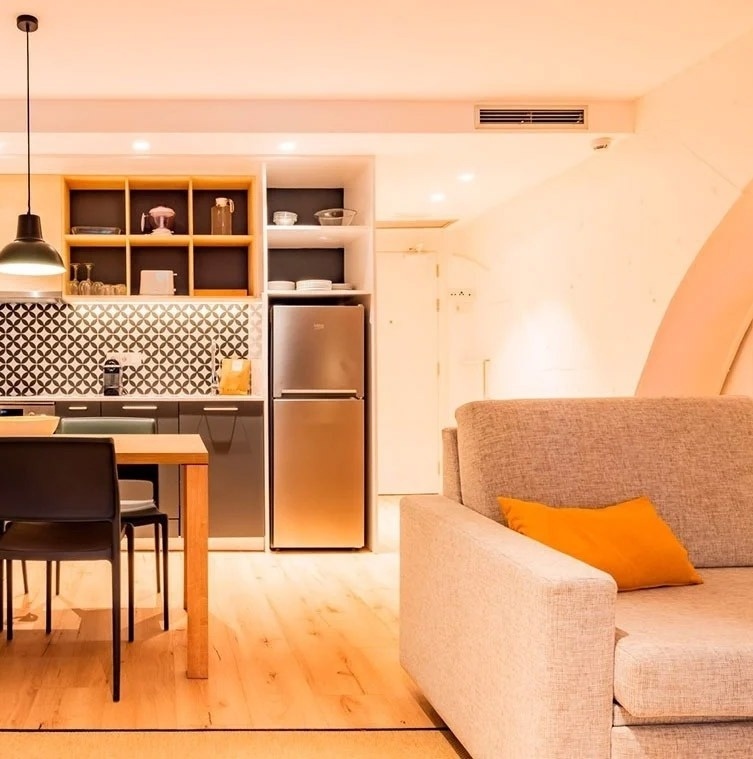 a small kitchen with a stainless steel refrigerator