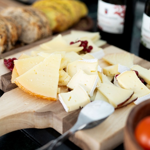 Cheese board with wine and bread, perfect for a bohemian hotel stay.