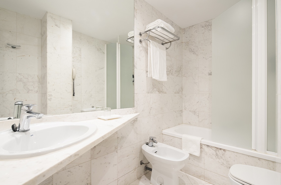 Bohemian Hotels bathroom: sink, bidet, bathtub, and shower.