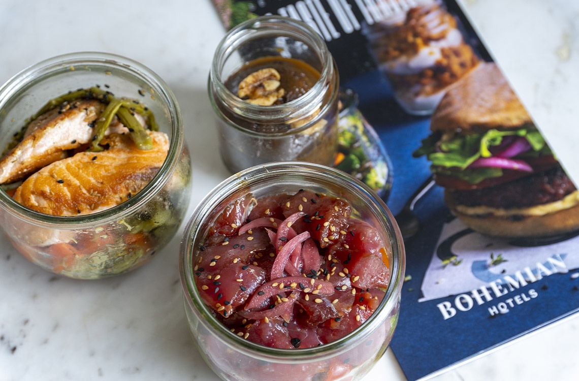 Bohemian Hotels: Delicious salmon and tuna poke bowls in jars, perfect for a fresh meal.