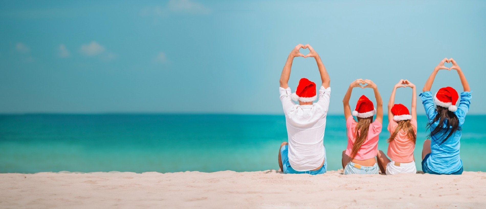 a hat and sunglasses are on the beach near the water