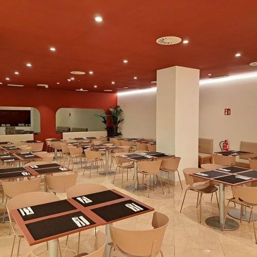 a restaurant with tables and chairs and a fire extinguisher