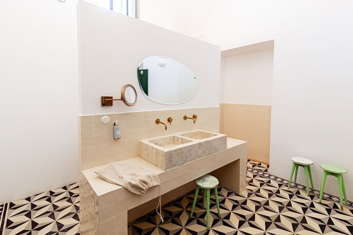 a bathroom with two sinks and a mirror