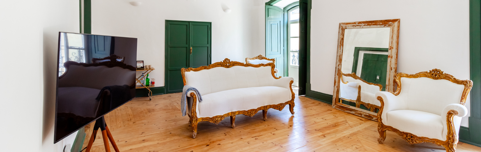 a living room with a couch a chair and a large mirror