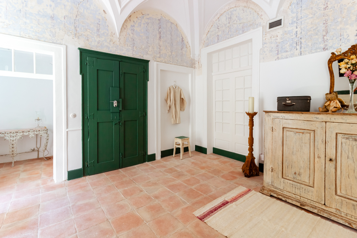 a bedroom with a large bed and two chairs