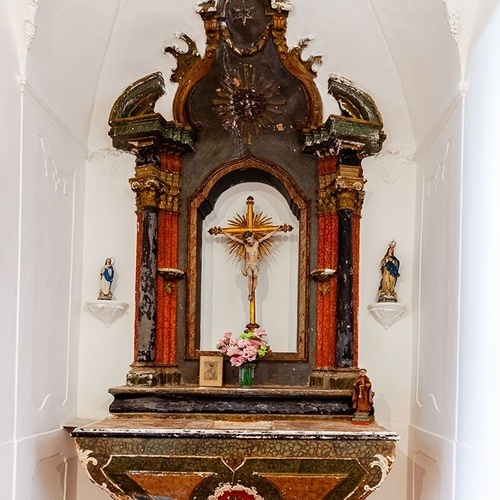 um altar em uma igreja com uma cruz e flores