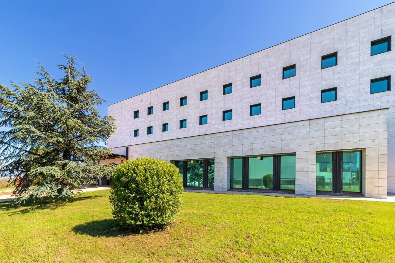 a building with a lot of windows and a tree in front of it