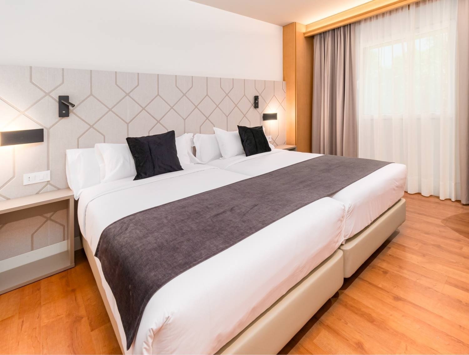 a hotel room with a large bed and a window