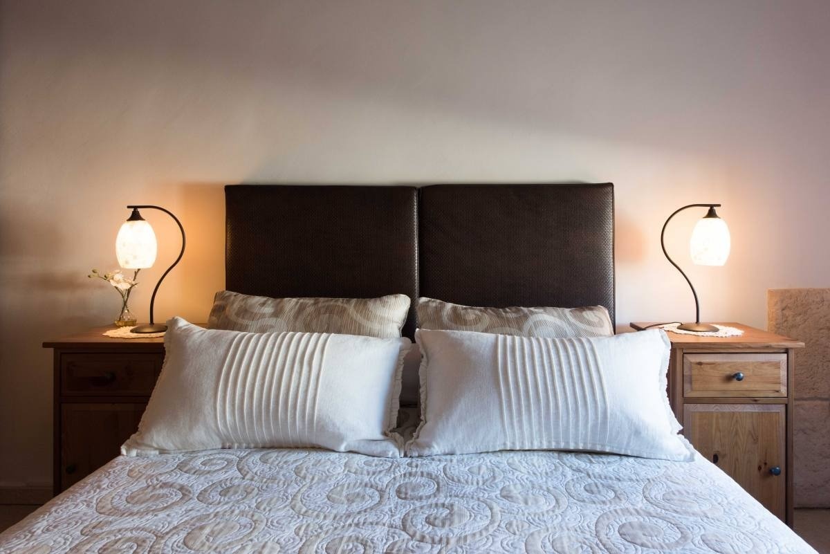 a bed with two lamps on either side of it