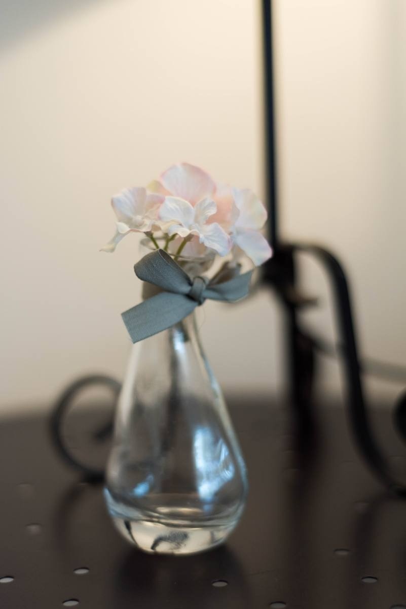 a small glass vase with flowers in it on a table