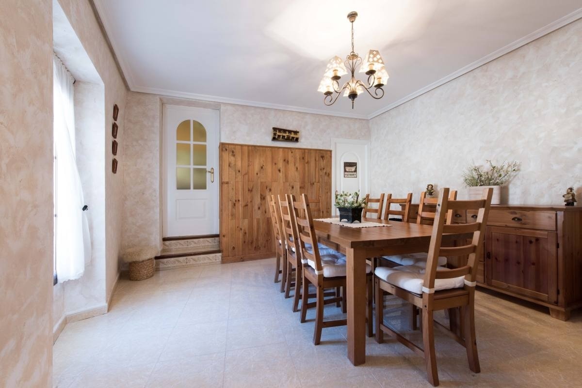 a dining room with a table and chairs and a chandelier