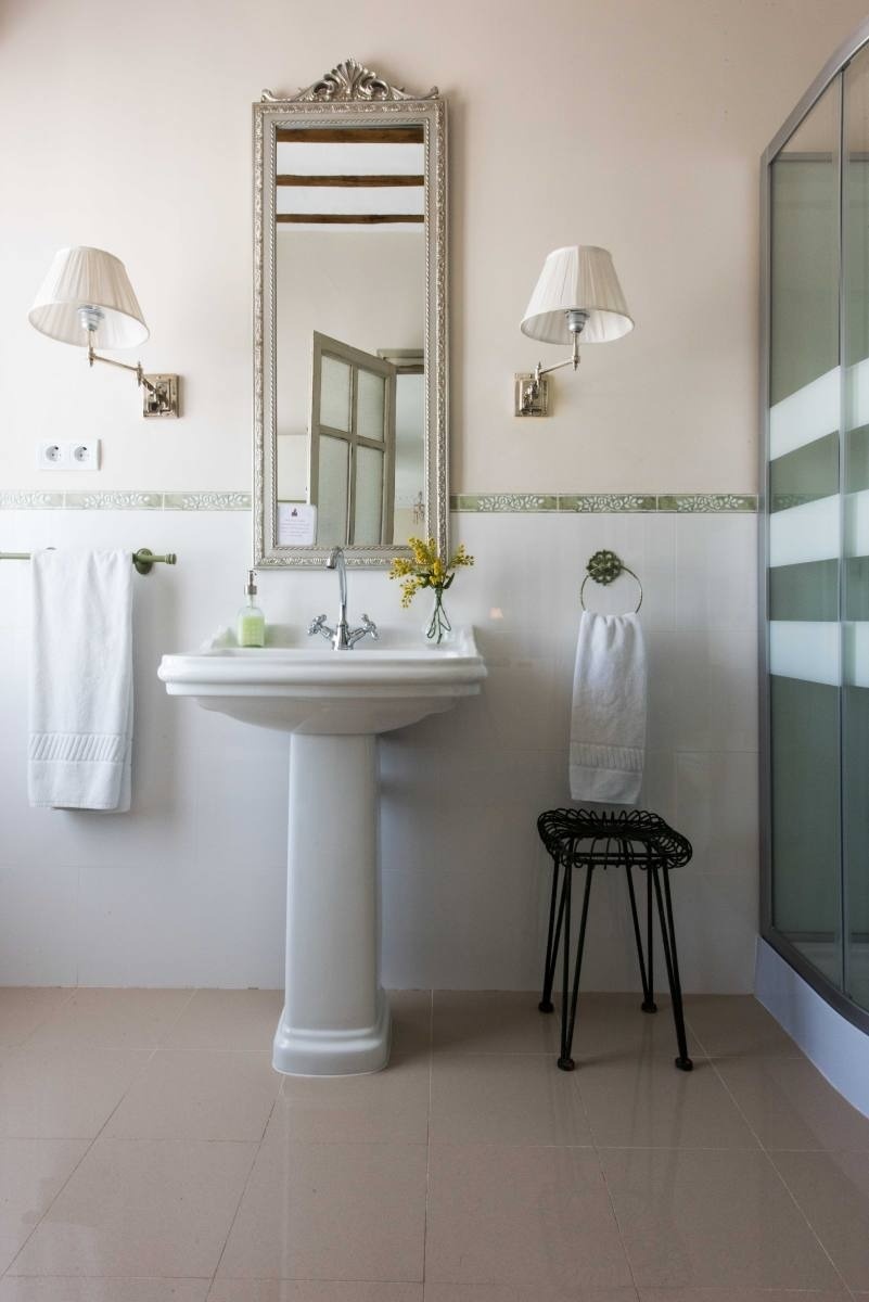 a bathroom with a pedestal sink and a mirror