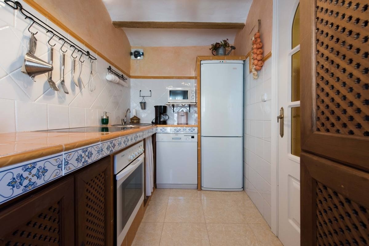 a kitchen with a white refrigerator and a microwave