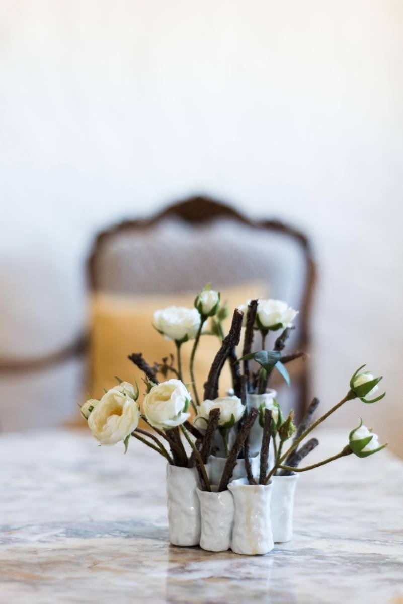 white flowers in small vases on a table