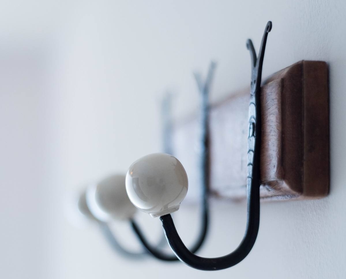 a row of hooks hanging on a white wall