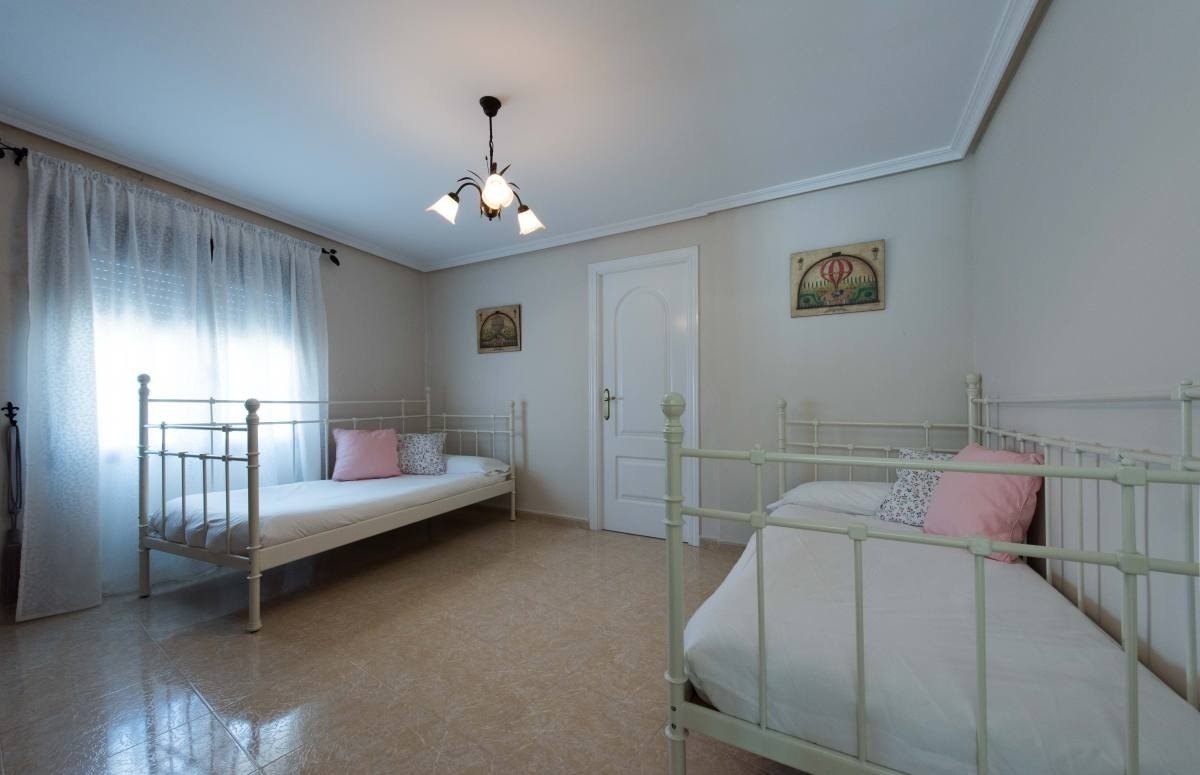 una habitación con dos camas y dos cuadros en la pared