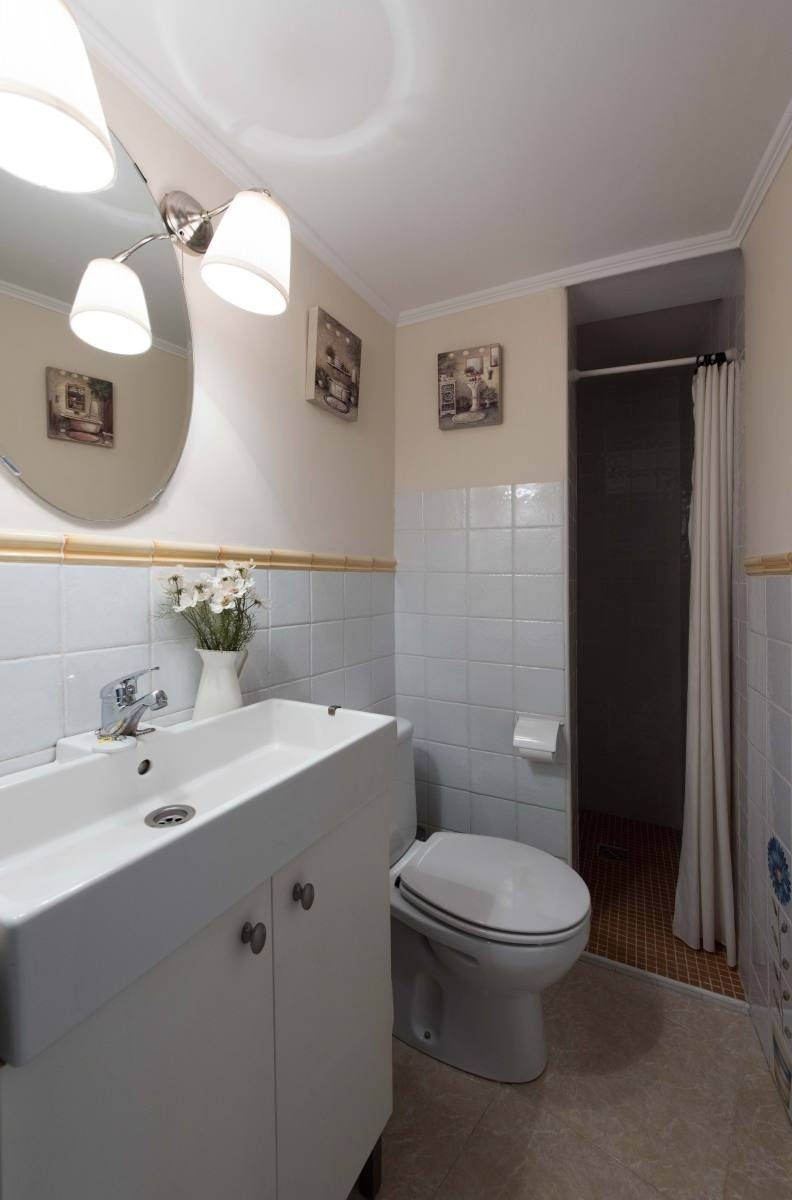 a bathroom with a toilet a sink and a mirror