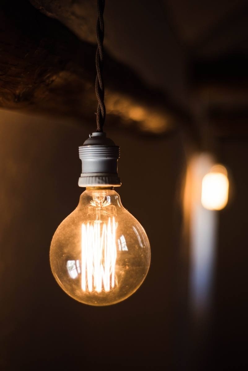 a light bulb is hanging from the ceiling and is lit up