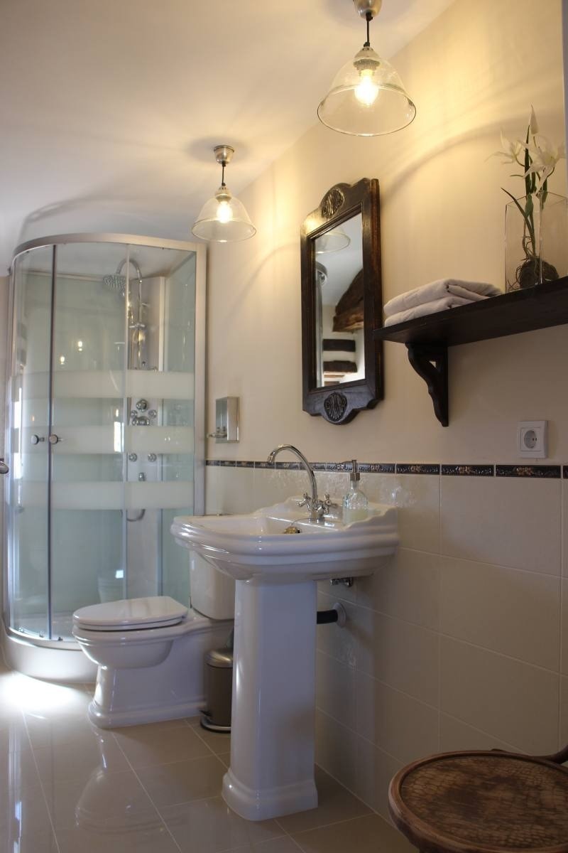 a bathroom with a pedestal sink and a toilet