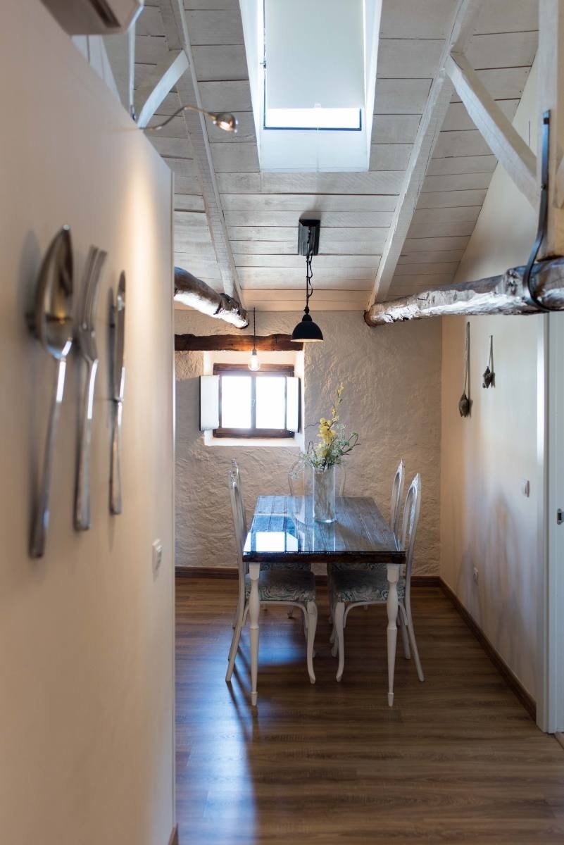 a dining room with a table and chairs and a window