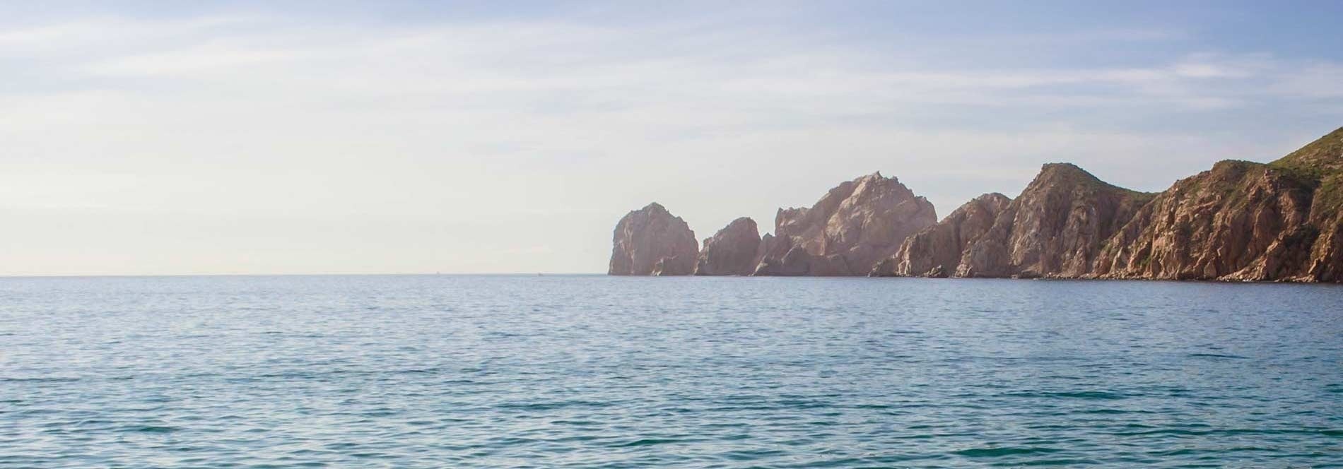 a large body of water with mountains in the background