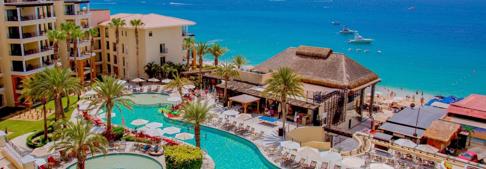 an aerial view of a resort with a large swimming pool