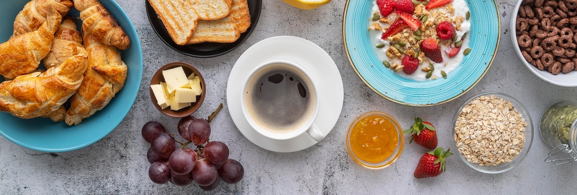 a table topped with a variety of food including a cup of coffee
