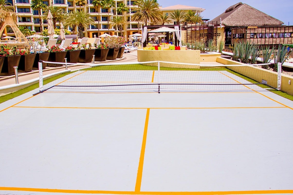 a tennis court in front of a large building