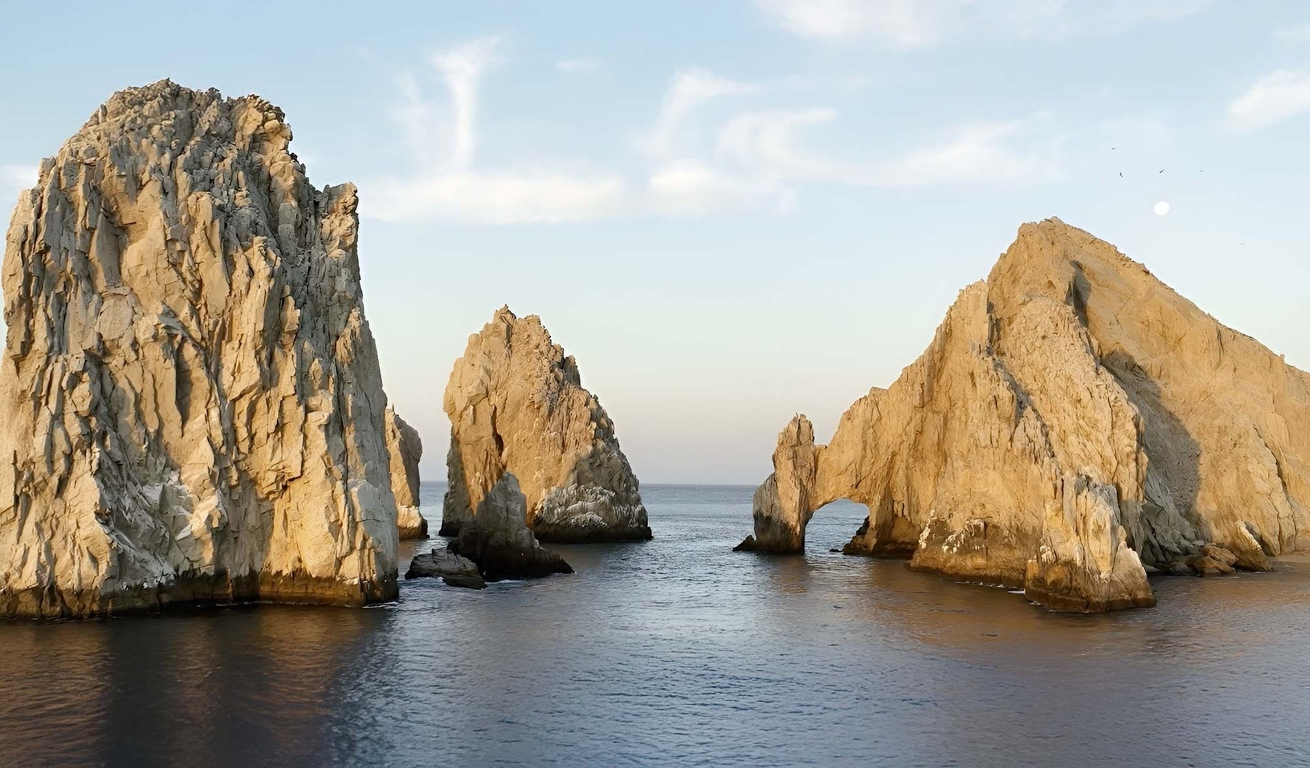 a large rock formation in the middle of the ocean