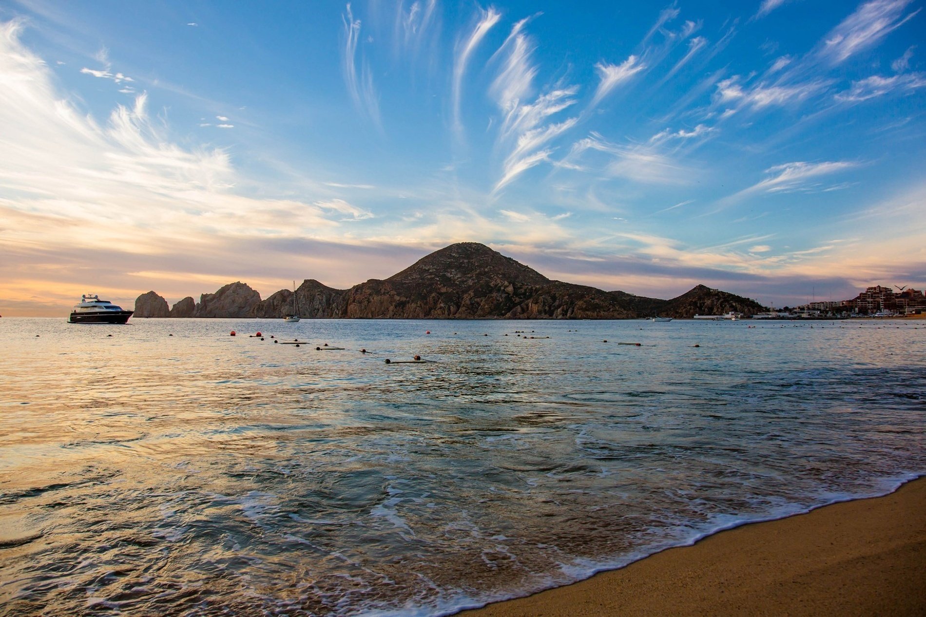 a large body of water with a mountain in the background
