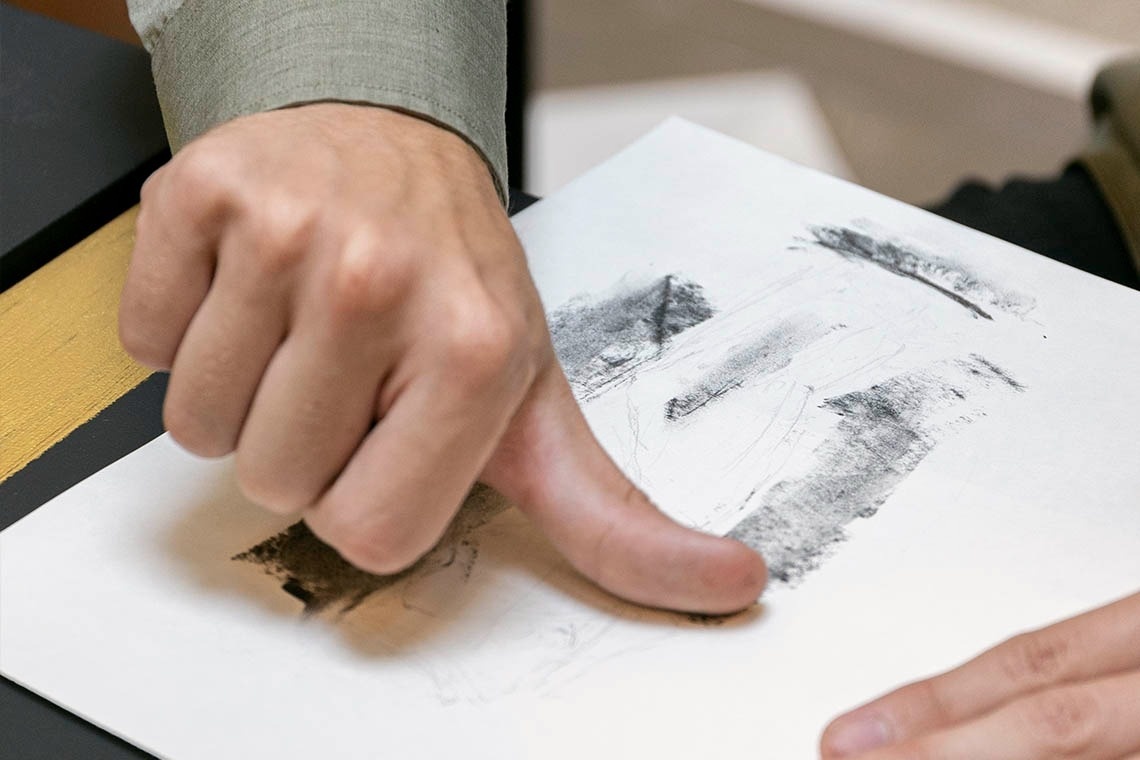 a person is holding a piece of paper with a fingerprint on it
