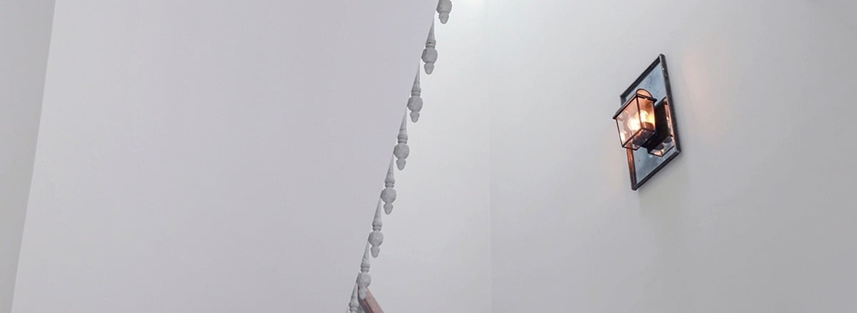 a white wall with a light on it