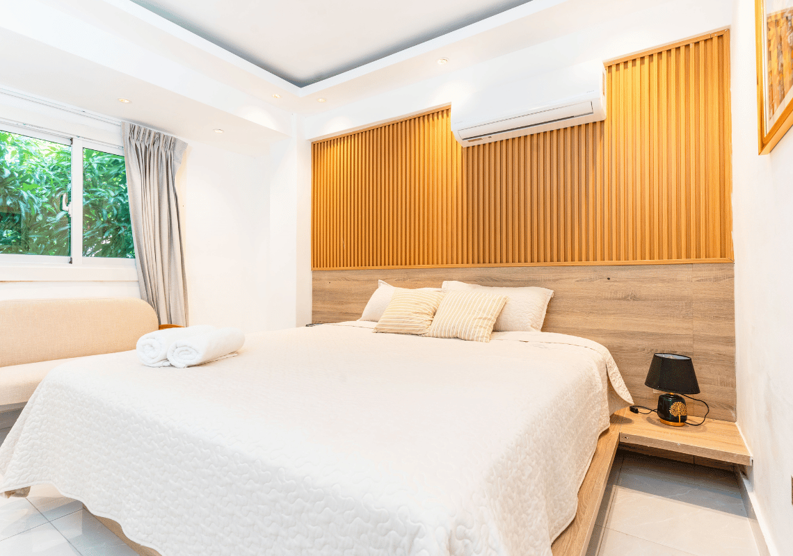 Habitación de hotel con cama cómoda, almohadas y decoración de madera. Casual: On The Beach Bayahibe
