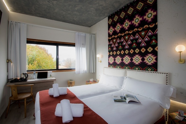 a hotel room with two beds and a book on the bed