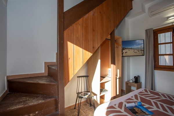 a wooden staircase with a picture on the wall above it