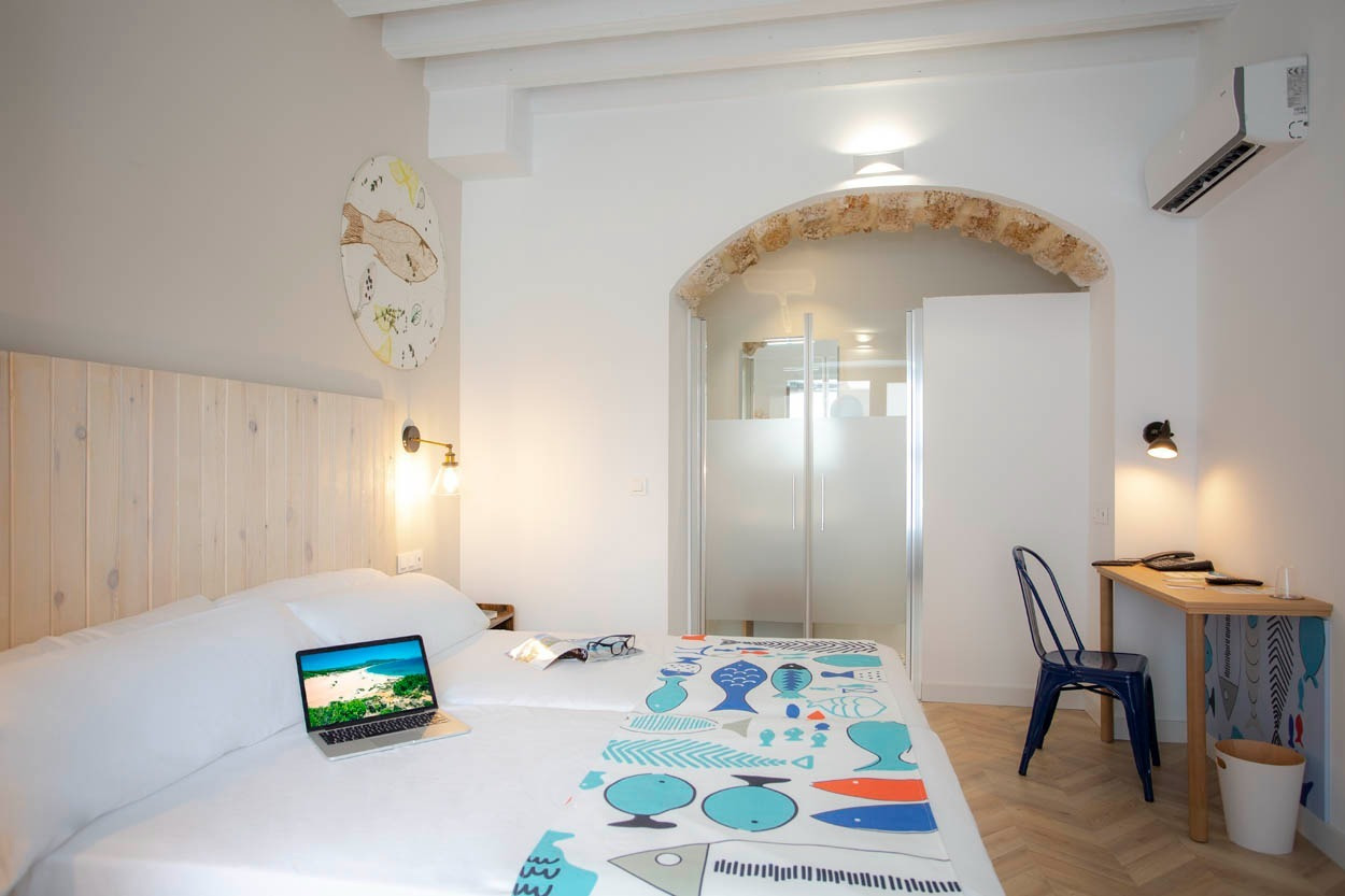 Zwei Betten, Laptop und Schreibtisch im Casual con Duende Cádiz – Hotel im historischen Zentrum von Cádiz.