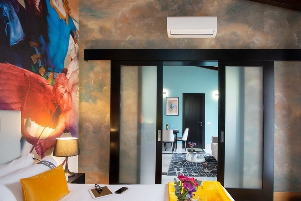 a bedroom with a sliding glass door leading to a living room