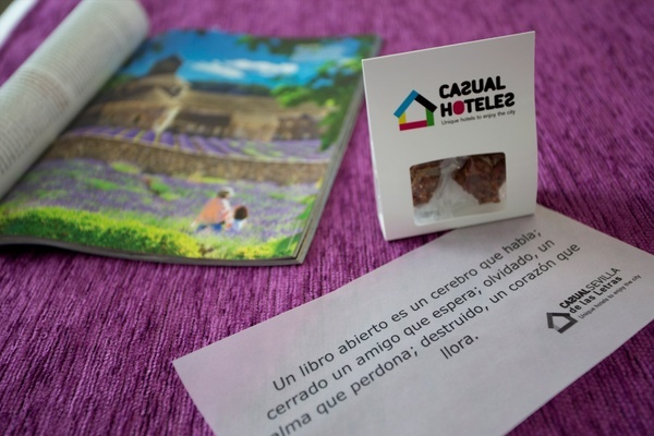 a box of casual hotele chocolates sits next to an open magazine