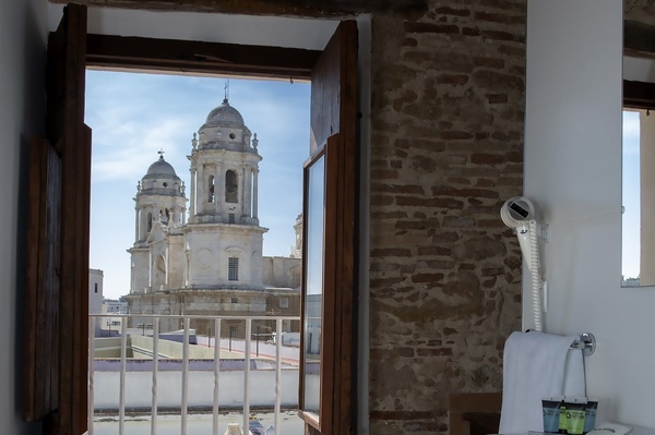 a bathroom with a view of a cathedral and a bottle of shampoo and conditioner